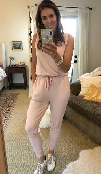 reviewer wearing the light pink jumpsuit