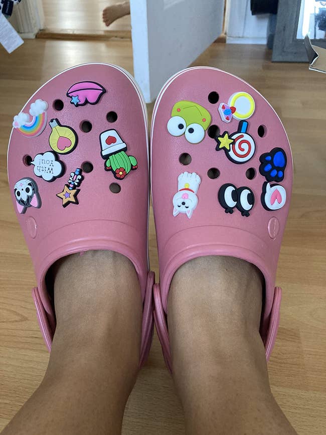 Reviewer photo of the pink platform crocs with little trinkets attached in the holes
