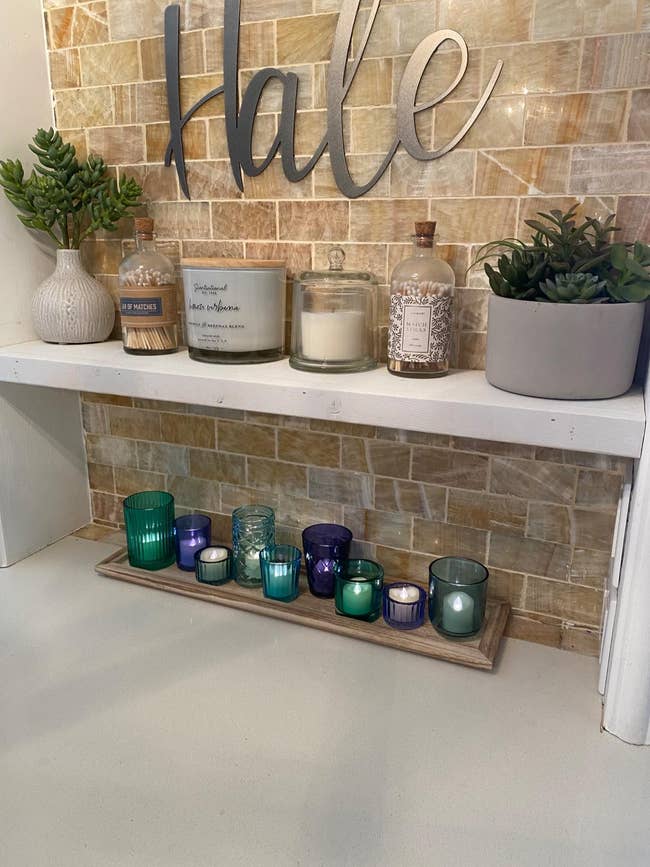 Reviewer's votives are shown on a well decorated shelf 