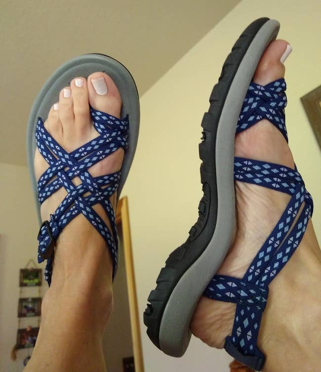 Person wearing blue patterned strappy sandals, showcasing the design for a shopping article