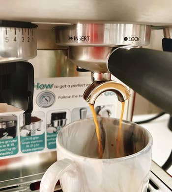 closeup of coffee pouring from reviewer's machine