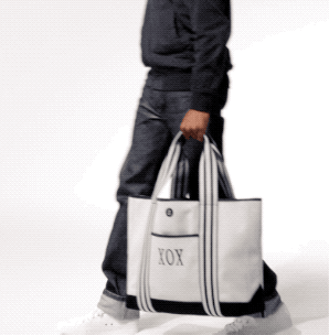 model with blue and white tote with XOX monogram