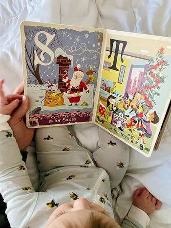 a reviewer's child reading the holiday book
