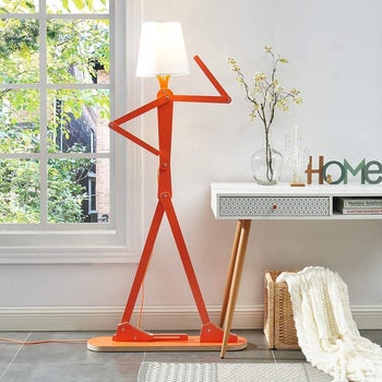 the person-like shaped floor lamp with a lamp shade where the head would be
