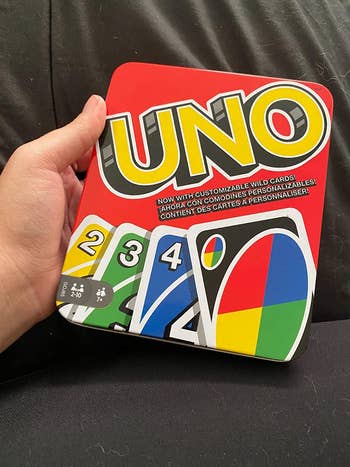 A reviewer's Uno game tin