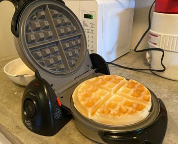 a cooked waffle inside of the waffle iron