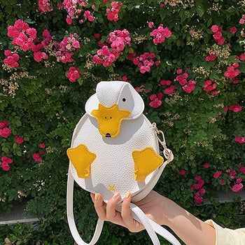 white and yellow crossbody shaped like a duck