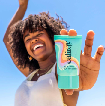 model holding bottle of primer