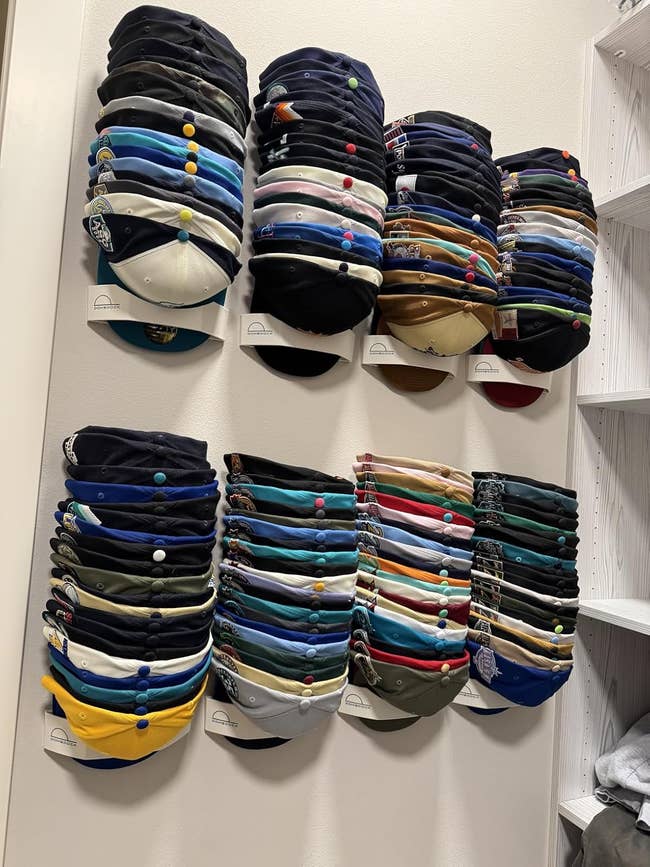 Stacks of shot   caps displayed connected  partition  hooks successful  a closet, showcasing assorted  designs, cleanable   for organizing headwear collections