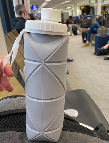 The grey water bottle sitting up right