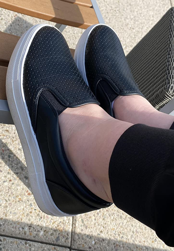 a reviewer wearing the shoes in black 
