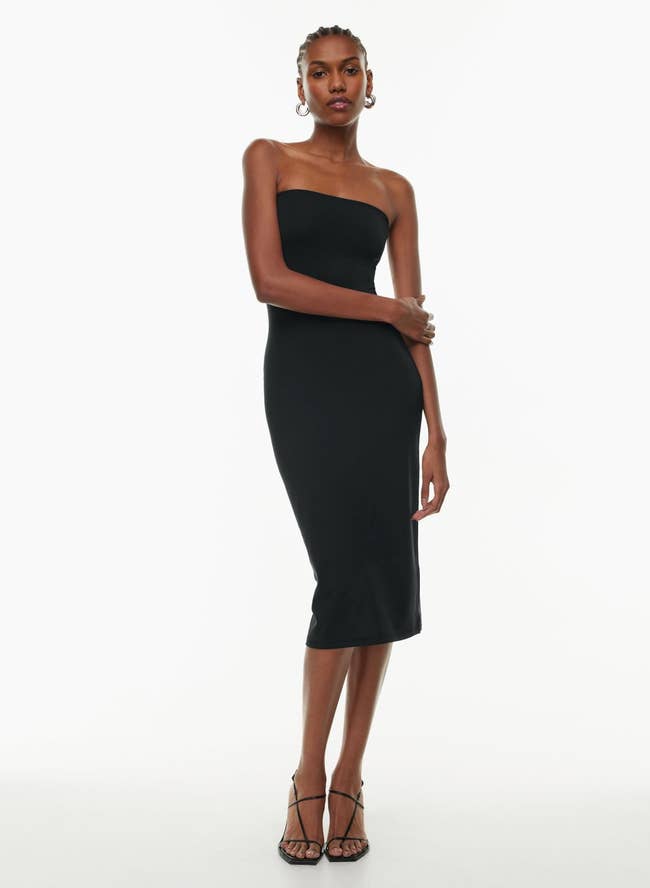 Model wearing a strapless black midi dress