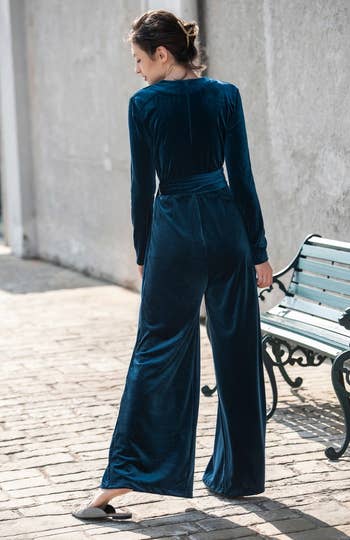 back of model wearing the blue velvet jumpsuit