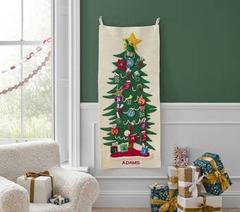 a long rifle paper tapestry advent calendar with felt pieces