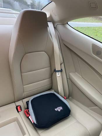 reviewer image of the booster seat in a car