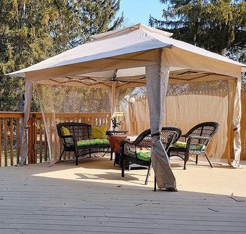 reviewer photo of the white pop up gazebo on a deck