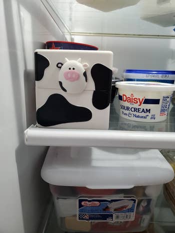 the cow theme cube container on a fridge shelf