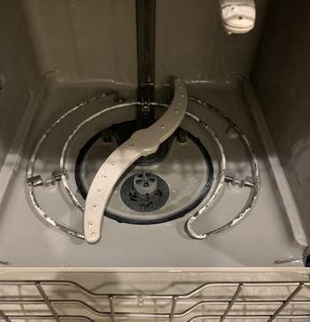 a reviewer photo of the same dishwasher looking visibly cleaner 