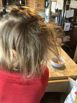a child with a huge knot in their hair