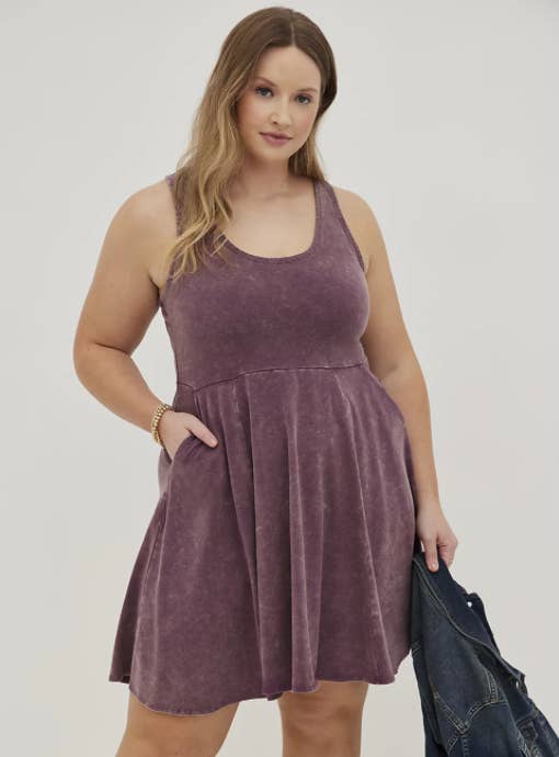 a model in a dark wash purple skater dress