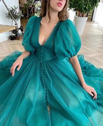 a model posing in the teal dress