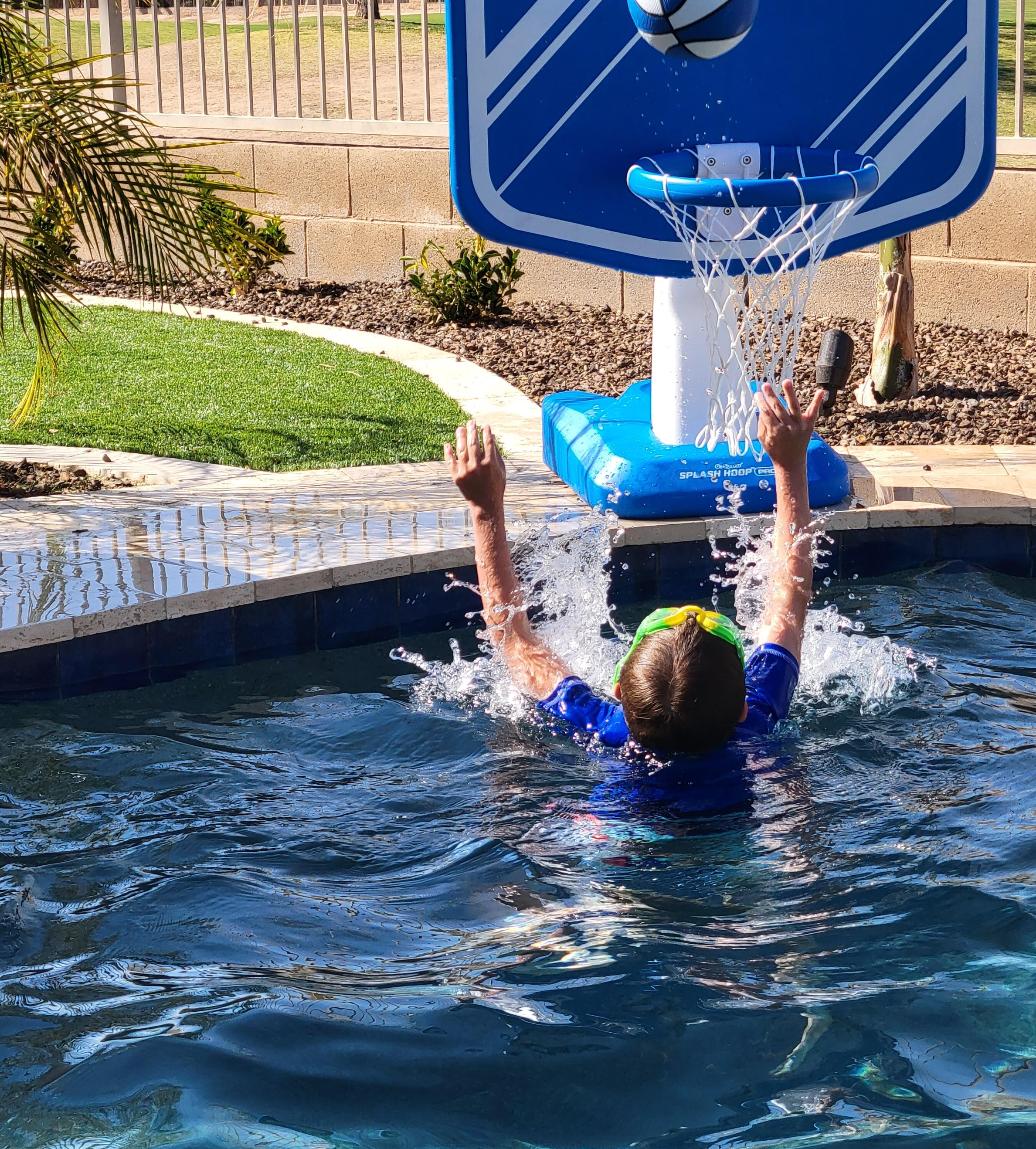reviewer photo of someone throwing ball into pool basket ball hoop