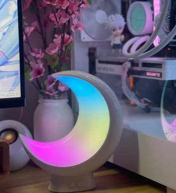 reviewer's color-changing moon lamp in a dimly lit room