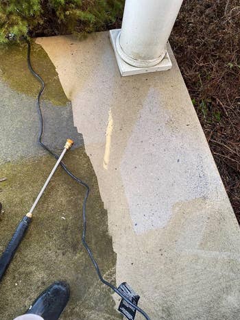 Pressure washer cleaning a dirty concrete surface
