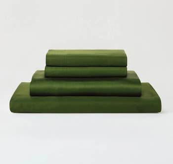 a pile of the sheets in forest green folded in a pile 