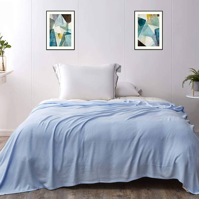 Light blue blanket over a bed