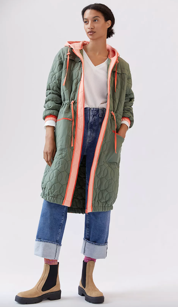 model wearing green, red, and pink quilted jacket