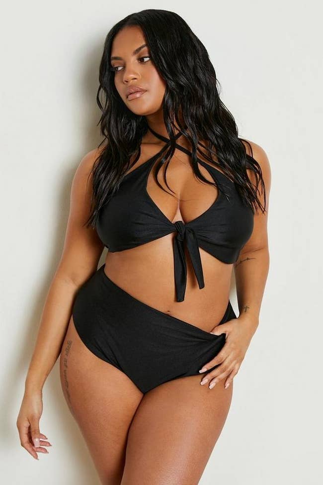 model posing in black halter bikini