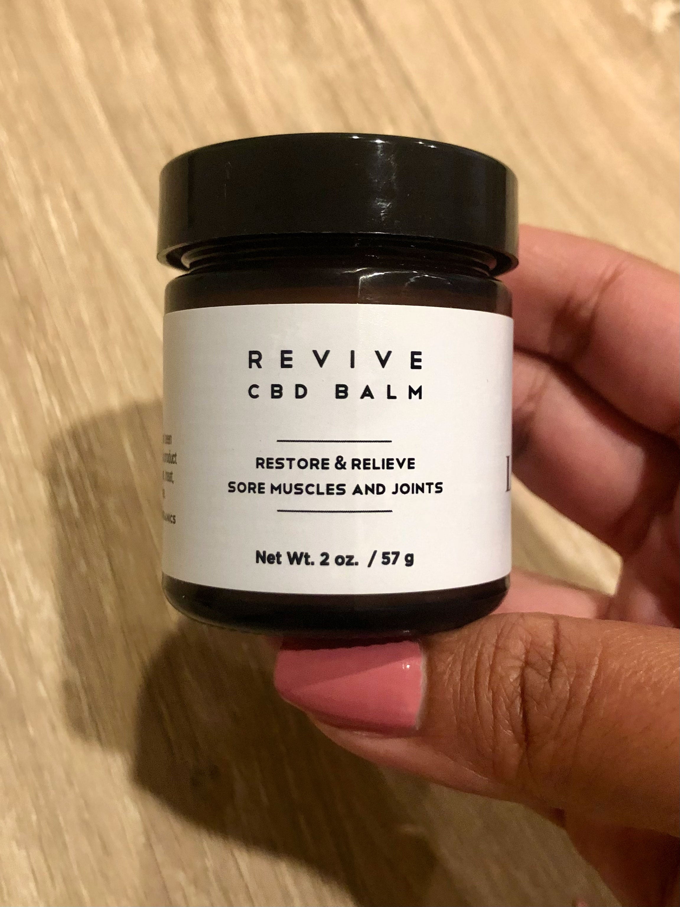 BuzzFeed photo researcher Christina Baez holds container of the CBD balm