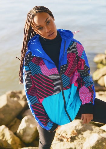 model wearing the blue, pink, and black windbreaker