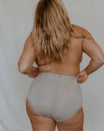 back view of topless model, a different one, wearing same briefs