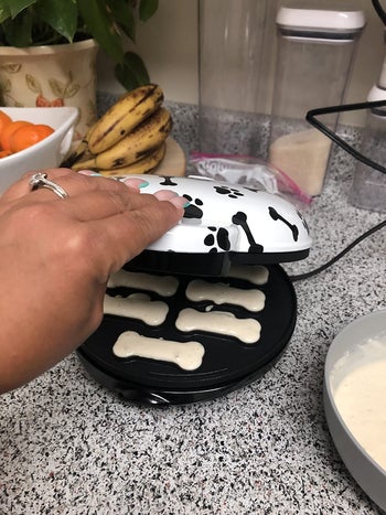 reviewer pic closing the treat maker with the bone-shaped wholes filled with dough