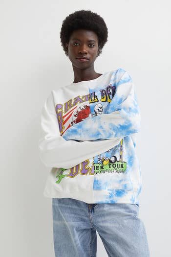 a model wearing a grateful dead sweatshirt with two designs combined into one