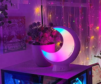 the color-changing moon lamp in a dimly lit room