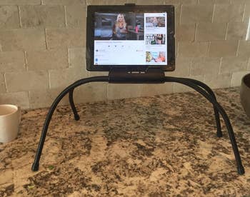 the stand on a countertop holding a tablet