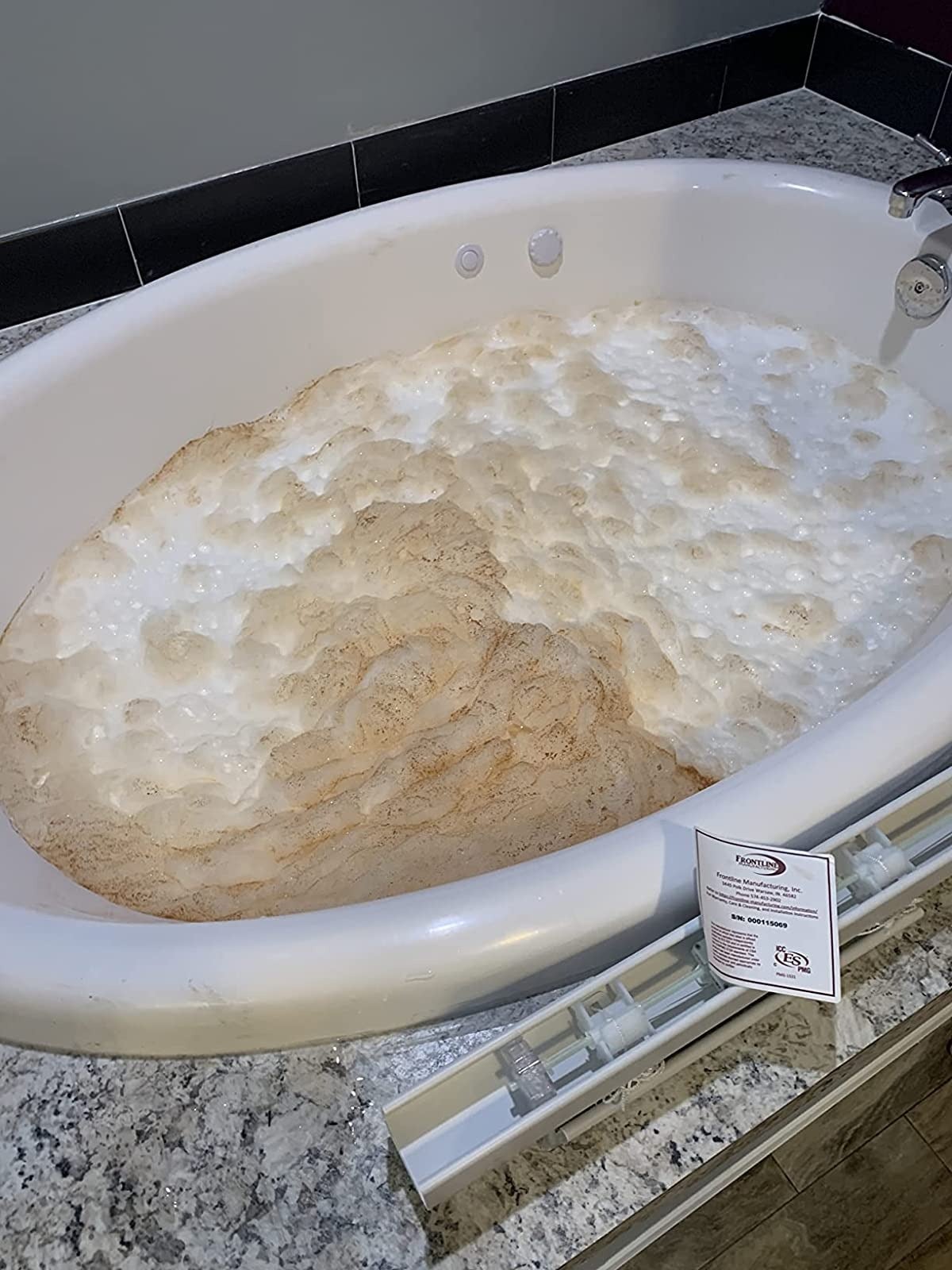 reviewer image of a jetted tub spewing out dirty foam