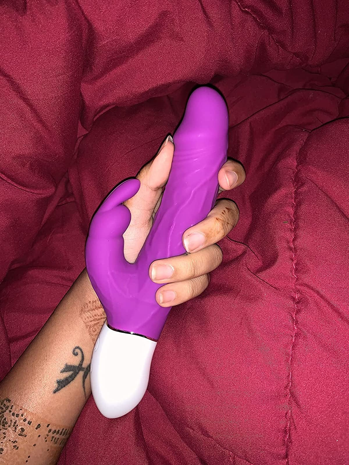 Reviewer holding pink and white rabbit vibrator