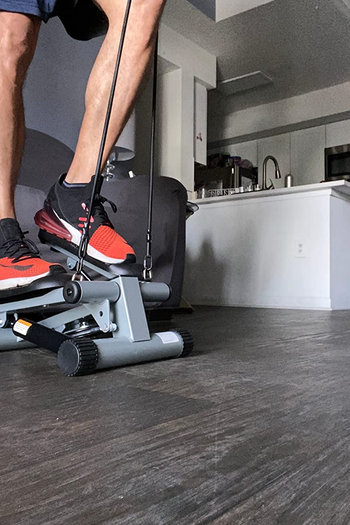 a person using the mini stepper at home
