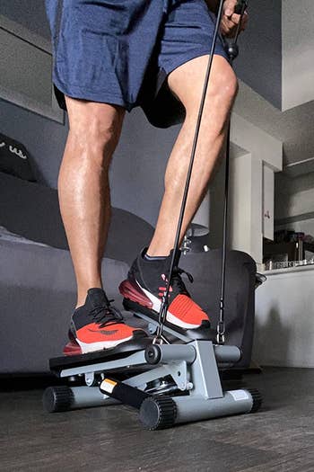 a person using the mini stepper at home