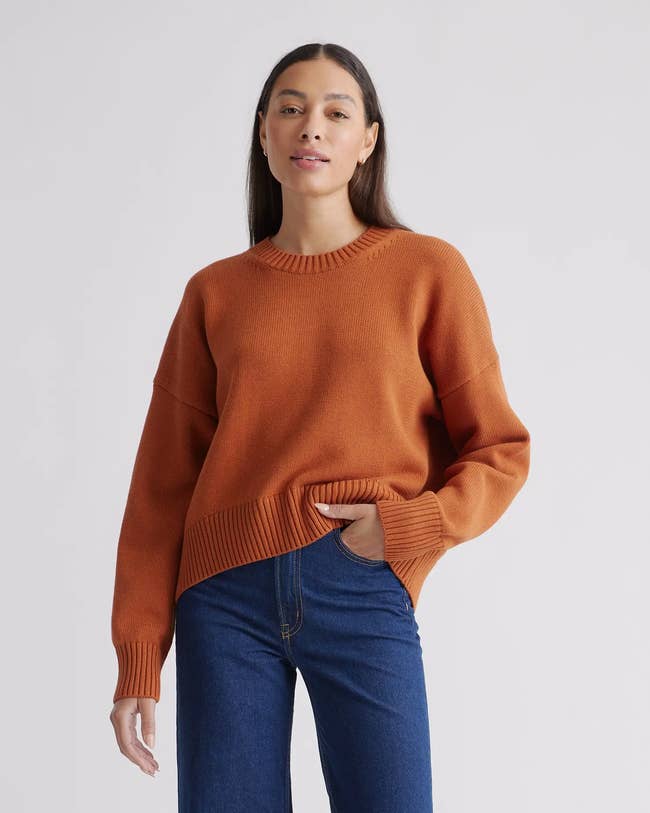 model wearing the sweater in orange
