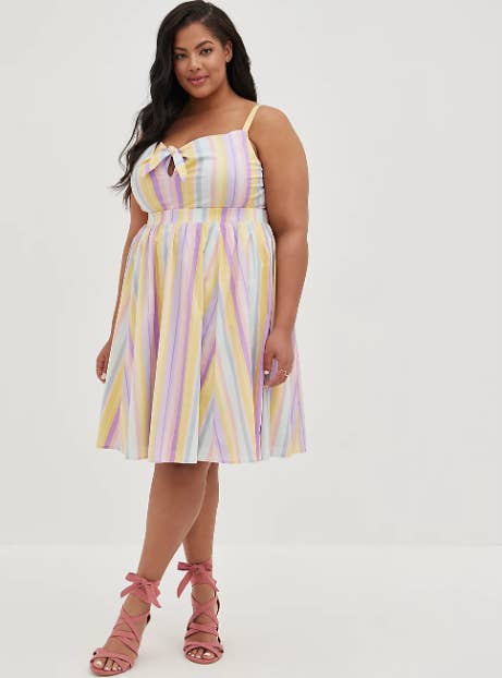 model in fit and flare pastel yellow mint and lavender knee length sundress with tie at bust