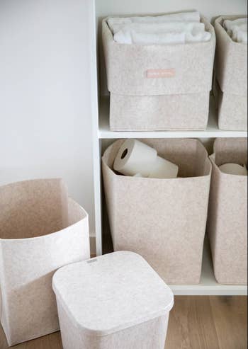 oatmeal-colored felt storage bins in shelves