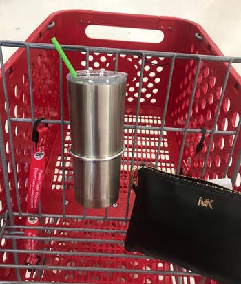 a reviewer photo of a tumbler cup in the cup holder that''s mounted on a Target cart 