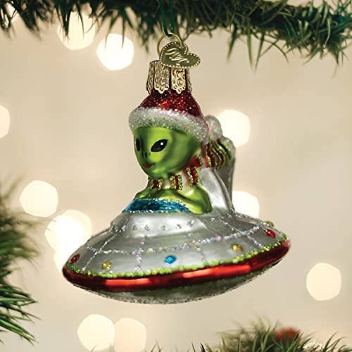 an ornament of an alien driving a space ship