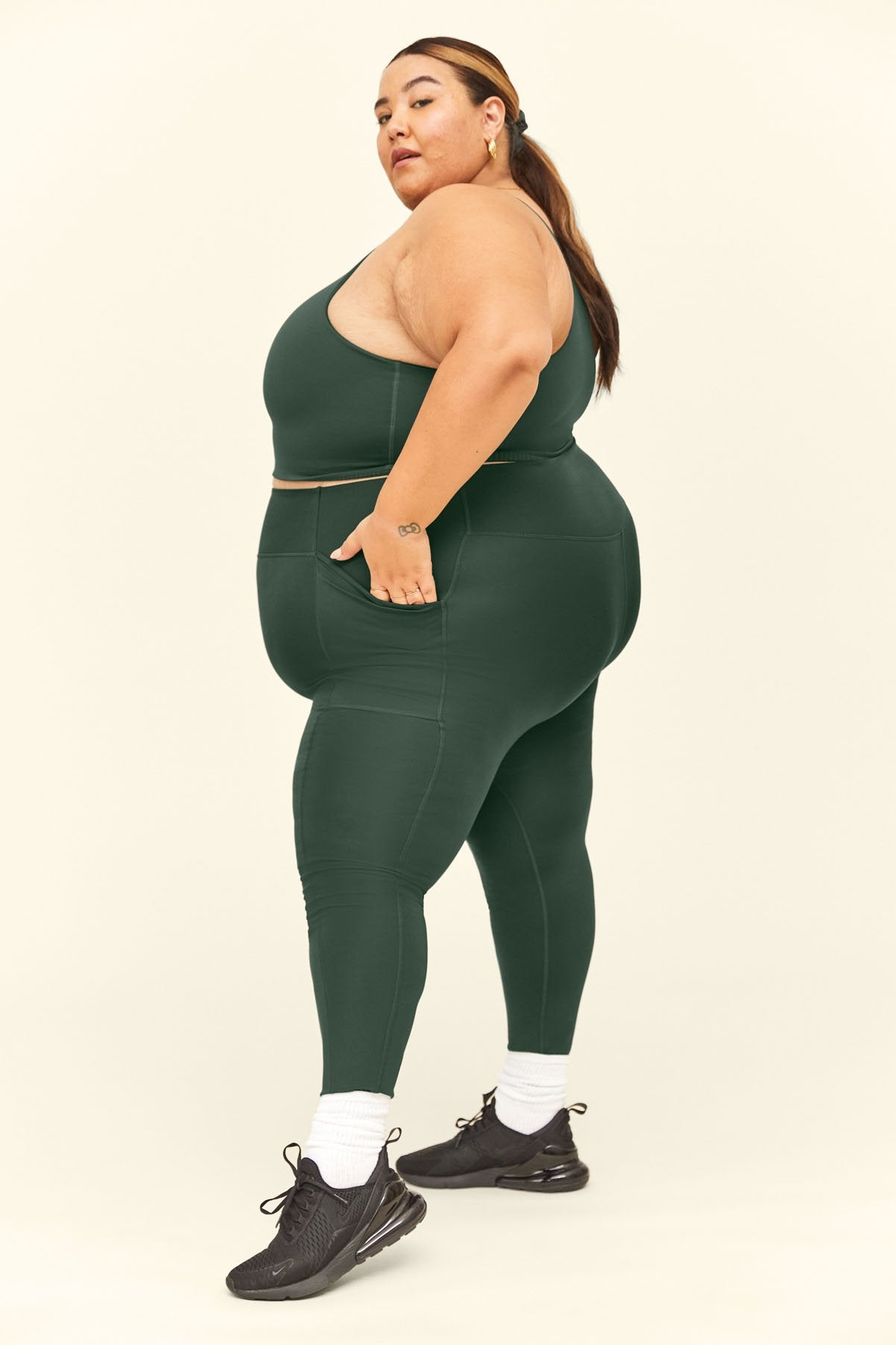 a model wearing green leggings and a matching top