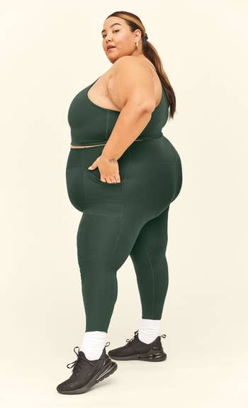 a model wearing green leggings and a matching top
